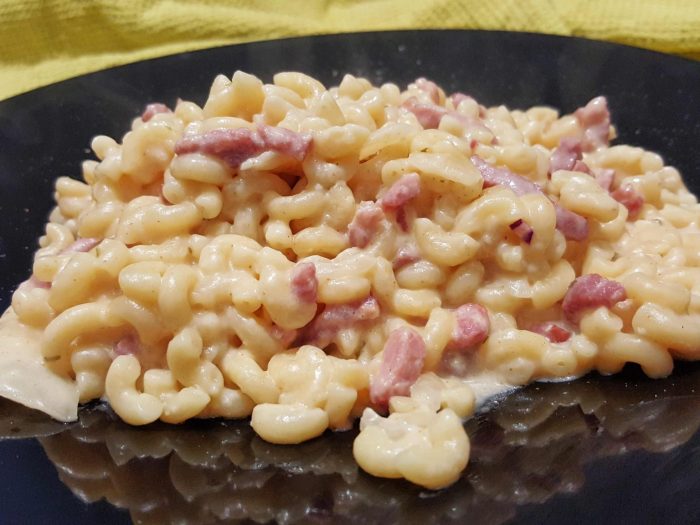 Pasta with soft creamy cheese and ham cubes